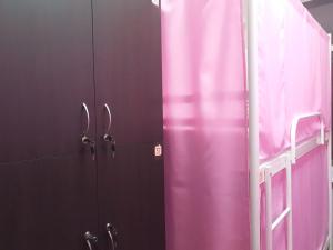 a room with pink and purple walls with scissors at Hostel 777 Vokzal in Kyiv