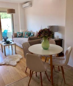 a living room with a table with a vase of flowers on it at Marina Residence in Becici