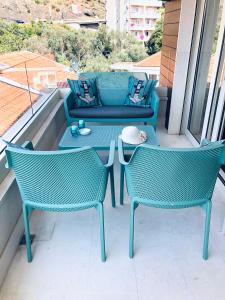 a patio with two chairs and a table and a couch at Marina Residence in Becici