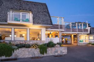 a house with a balcony on top of it at Cambria Beach Lodge in Cambria