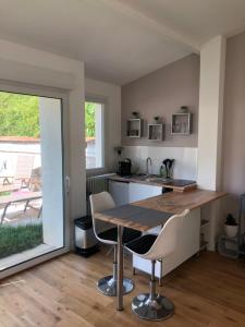 eine Küche mit einem Tisch und Stühlen im Zimmer in der Unterkunft studio maisonnette avec jardin, Nancy Thermal, Artem in Nancy