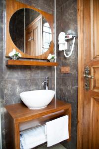 a bathroom with a sink and a mirror at Cankaya Konaklari Hotel in Hatay