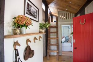 a room with a staircase and a red door and a room at Chum Creek Hut in Chum Creek