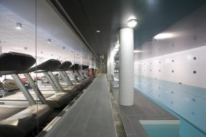 a row of exercise machines in a swimming pool at Hotel Realm in Canberra