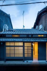 a building with two doors and two chairs on top at KOU Nishijin in Kyoto