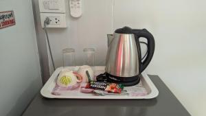 a coffee maker on a tray on a counter at Baan Suchanuch in Don Sak