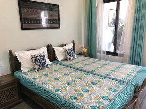 Tempat tidur dalam kamar di Kalpana Yoga Homestay