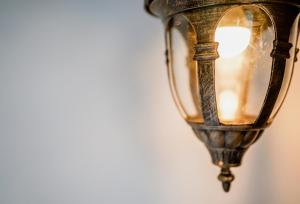 an old lamp hanging on a wall at Khaleej Mass Hotel Patong in Patong Beach