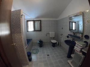 a bathroom with a sink and a toilet and a mirror at Apartments Malina in Tučepi
