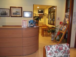 a shop with a counter and a chair in a room at Hotel Simeon in Tossa de Mar