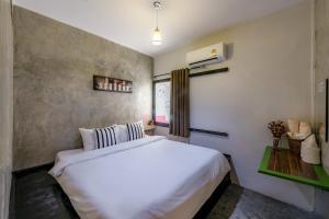 Tempat tidur dalam kamar di Costa Bed Hua Hin