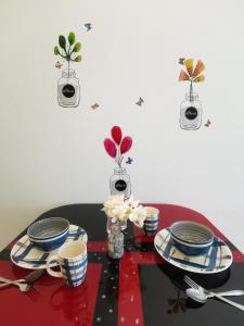 a table with blue and white plates and flowers on it at Taiping Centre Point Suite 9 by BWC in Taiping