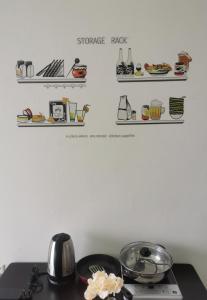 a kitchen counter with a stove top with shelves on the wall at Taiping Centre Point Suite 9 by BWC in Taiping