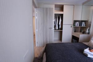 a small bedroom with a bed and a closet at Comfy Condo On Nut in Bangkok +2 photos