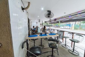 a bar with stools and a counter in a restaurant at RedDoorz @ Clarkview 21st Street Angeles City in Angeles