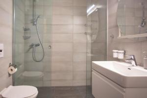a bathroom with a shower and a toilet and a sink at Apartment Edgar in Makarska