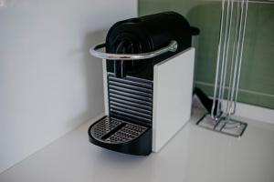 a black coffee maker sitting on a counter at Nannare' Rooms in Reggio Emilia