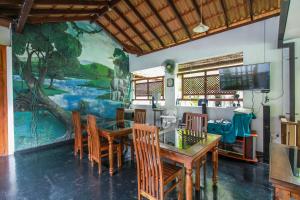 Villa 80 في بينتوتا: غرفة طعام مع طاولة وكراسي وجدارية