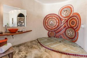 a bathroom with a large mandala on the wall at Singa Lodge - Lion Roars Hotels & Lodges in Port Elizabeth