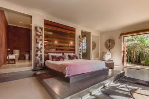 a bedroom with a large bed and a large window at Singa Lodge - Lion Roars Hotels & Lodges in Port Elizabeth