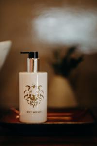 a bottle of new lotion sitting on a table at Singa Lodge - Lion Roars Hotels & Lodges in Port Elizabeth