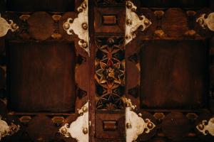 a wooden door with a design on a wall at Singa Lodge - Lion Roars Hotels & Lodges in Port Elizabeth
