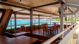 a dining room with a table and chairs on a boat at Phinisi Hostel Bira in Bira