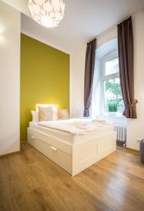 a bedroom with a large white bed in front of a window at Nena Apartments - Bergmannkiez ehm Traumbergflats in Berlin