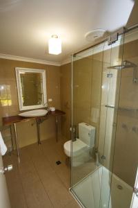 a bathroom with a toilet and a glass shower at Silvertrees in Margaret River Town