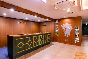 a lobby with a reception desk and a map of the world at Hotel Wing International Select Kumamoto in Kumamoto