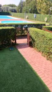 a brick walkway in front of a swimming pool at Residence degli Artisti in Desenzano del Garda