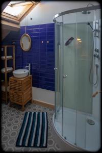 a bathroom with a glass shower and a sink at Grand studio duplex proche de la mer in Fécamp