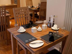 a wooden table with plates and hats on top of it at Langtrys in Blackpool