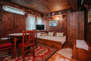 a bedroom with a bed and a table and a television at Kodjamanova House in Zheravna