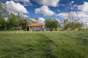 a group of people in a field near a house at Barak de Vinck in Ypres +15 photos
