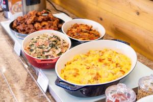 a buffet with bowls of food on a counter at Vessel Inn Sapporo Nakajima Park in Sapporo +93 photos