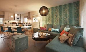 a living room with a couch and a dining room at Bosön Hotell & Konferens in Lidingö