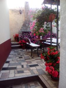 a patio with flowers and a table and chairs at Mon Perin Castrum - Studio Apartment Castel in Bale