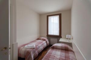 a room with two beds and a window at Appartamento Castleview Soave in Soave