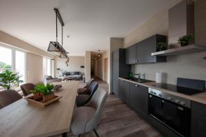 a kitchen and living room with a table and chairs at Hotel Altes Amtshaus in Reken