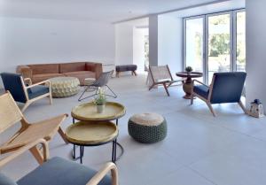 a living room with chairs and tables and a couch at ibis Styles Golden Sands Roomer Hotel in Golden Sands