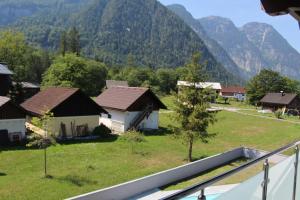 a view of a village with mountains in the background at Hideaway Obertraun in Obertraun