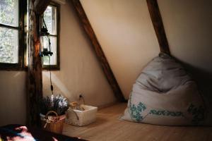 an attic room with a bean bag chair and a window at La Mama Anica in Porumbacu de Sus