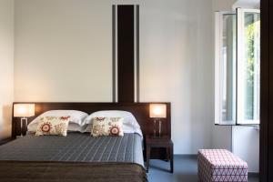 a bedroom with a large bed with two lamps on it at Residenza Termini in Rome