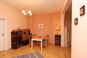 a kitchen and dining room with a table and chairs at Central Charming Home with Garden near Parking and NDK in Sofia