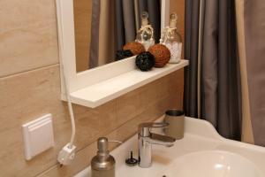 a bathroom with a sink and a mirror at Central Charming Home with Garden near Parking and NDK in Sofia +41 photos