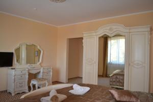 a bedroom with a bed and a dresser and a mirror at Tonal in Mukacheve