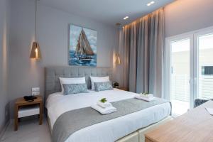 Postel nebo postele na pokoji v ubytování Melina Bay Boutique Hotel