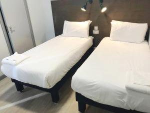 
A bed or beds in a room at Euro Hotel Wembley

