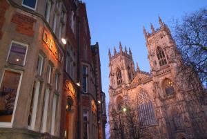 a church with a clock tower and a cathedral at The Dean Court in York